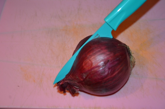 Chop the onion in half, vertically.