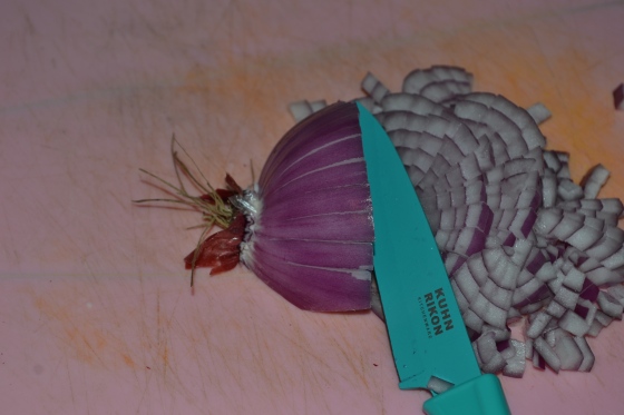 Now cut horizontally across your onion, stopping 1/2cm from the roots (which can now be discarded).